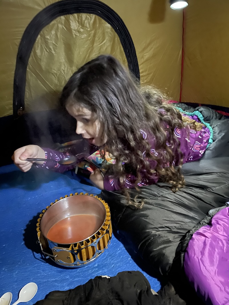 My daughter eating tomato soup
