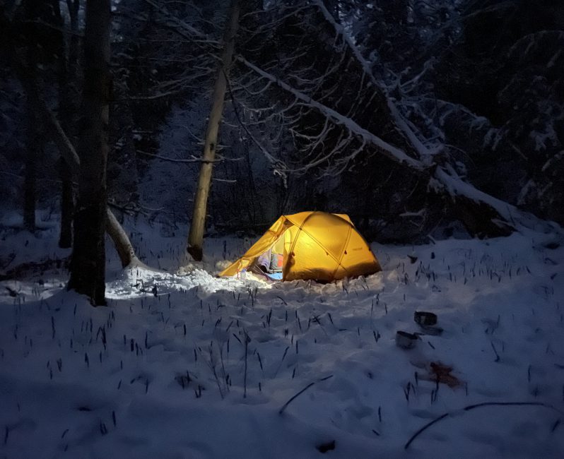 Glowing tent in the winter in Maine