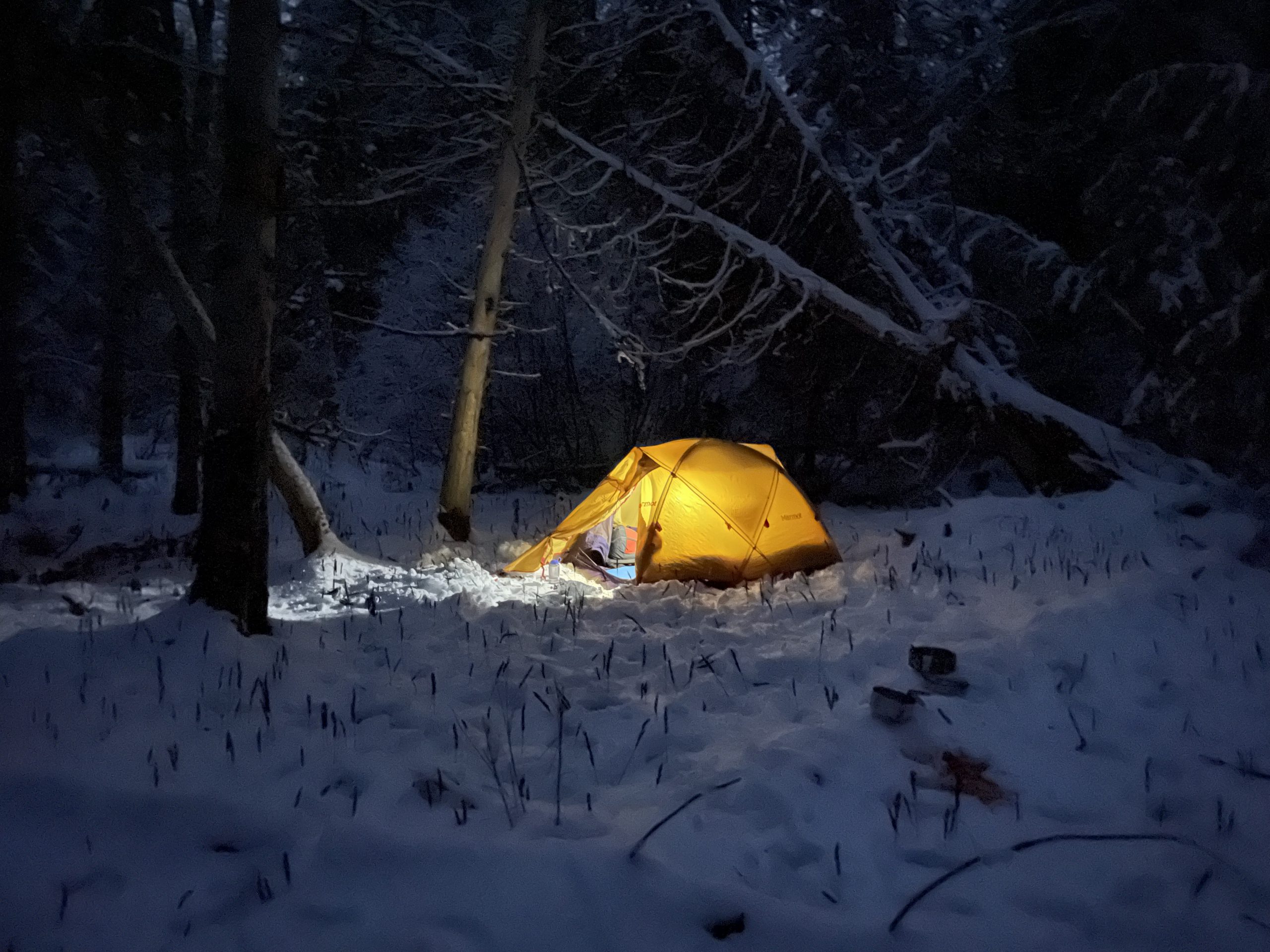 Glowing tent in the winter in Maine