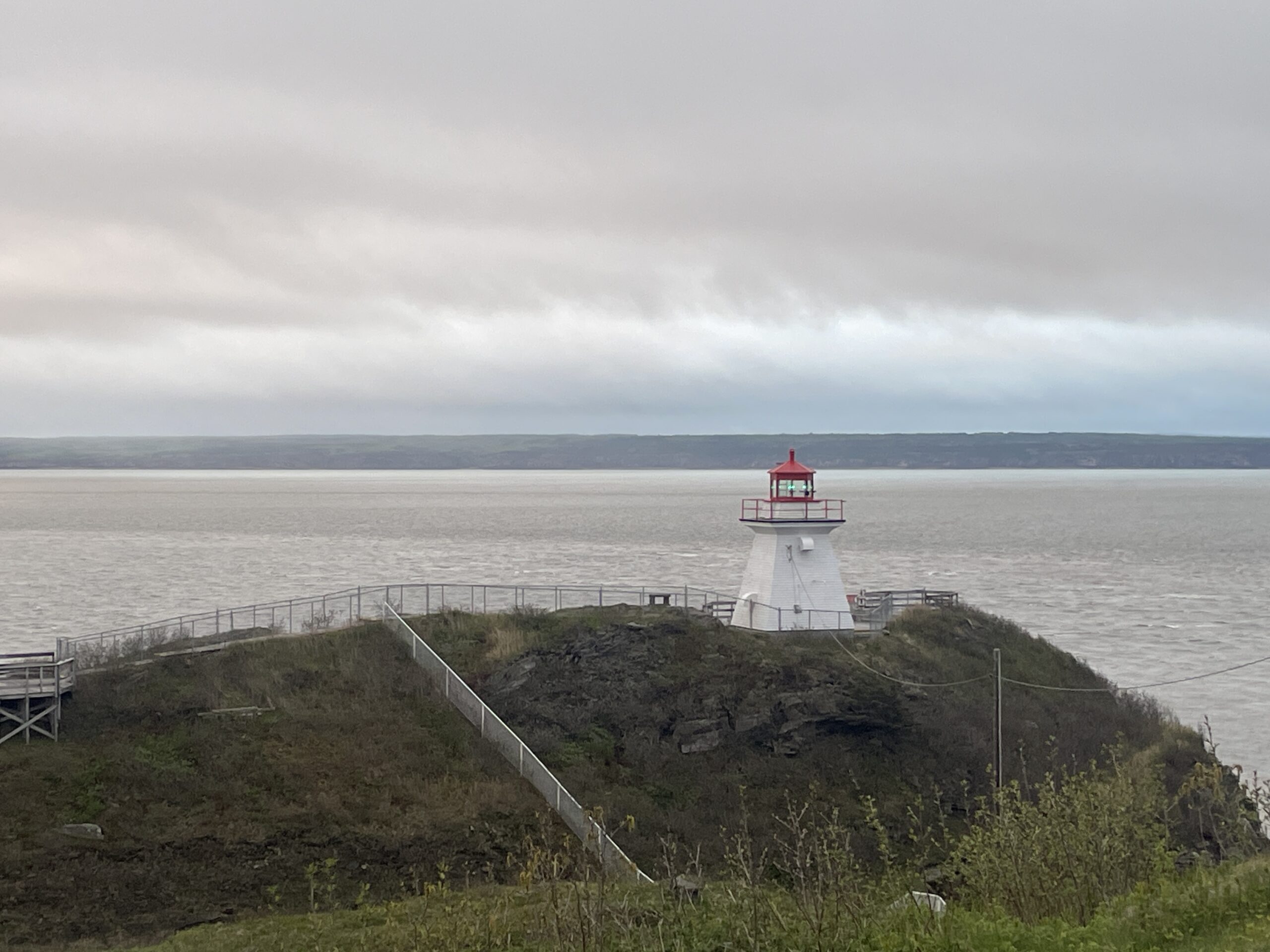 A lonely, tiny lighthouse sits on an overlook at Cape Enrage on the Bay of Fundy.