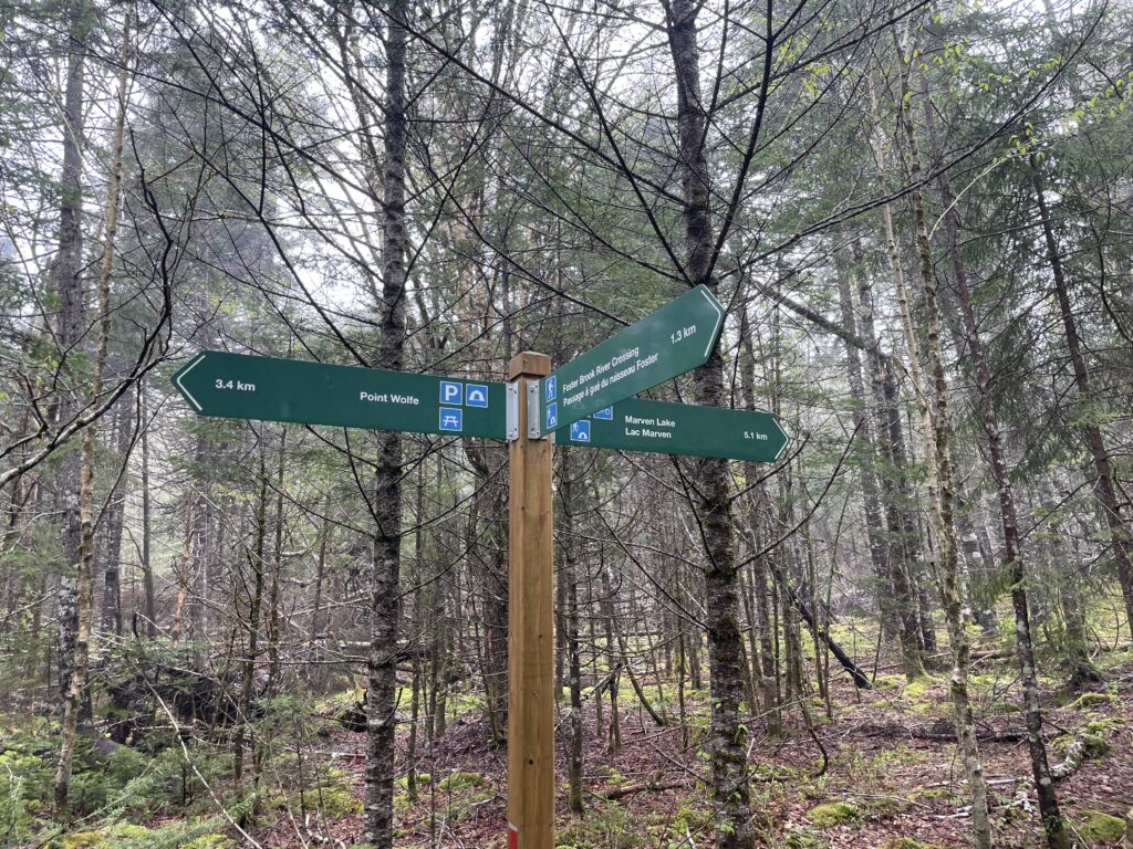 A sign indicating the distance between Point Wolfe, Foster Brook River Crossing, and Marven Lake in Fundy National Park.