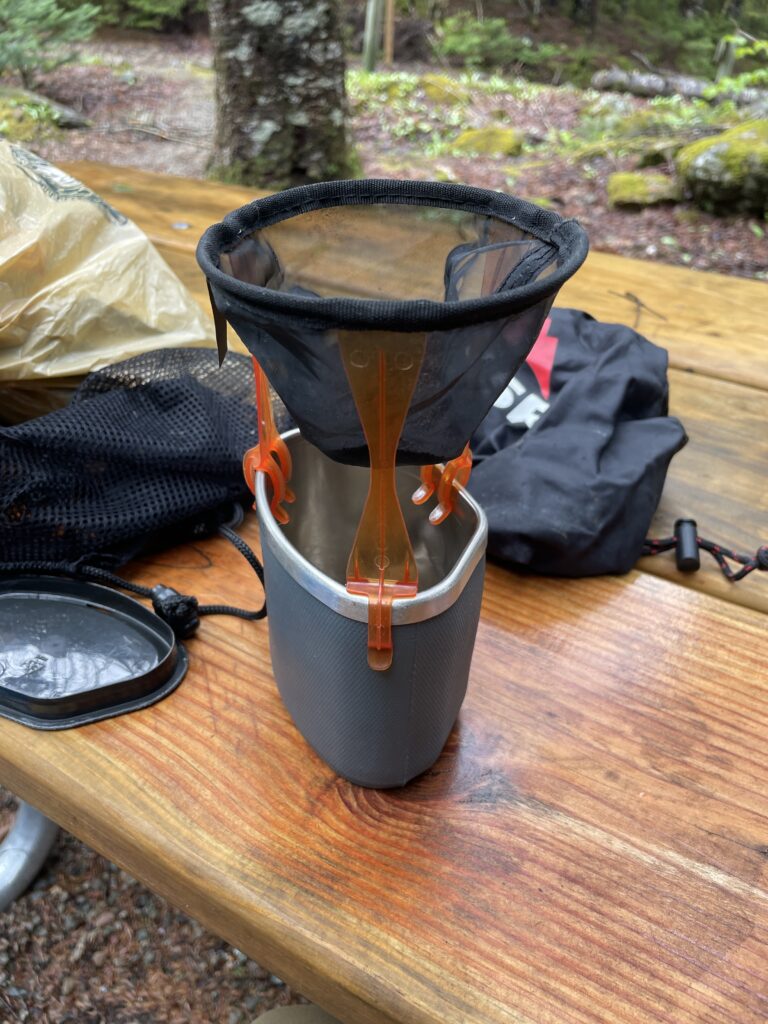 A GSR coffee drip sits on a MSR mug in the Fundy backcountry.